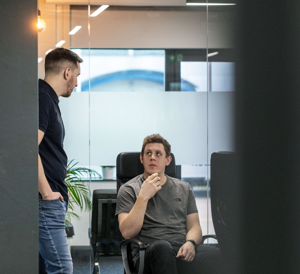 Employee eating an apple whilst in conversation