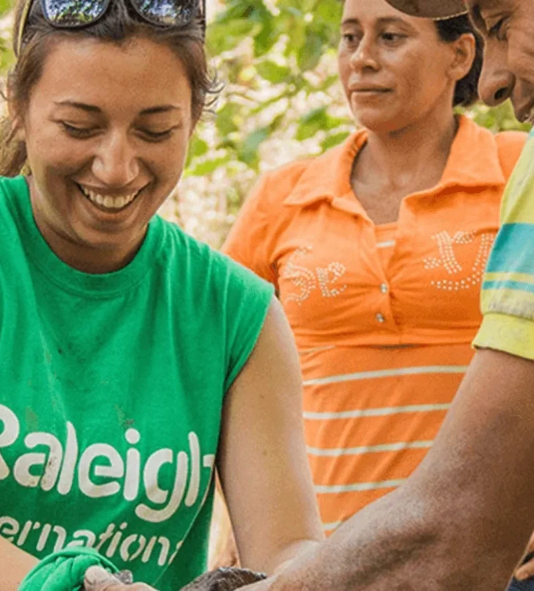 Raleigh International volunteer smiling with people